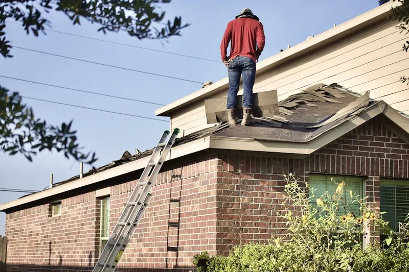 Professional roofer working on a residential roof in Bowleys Quarters